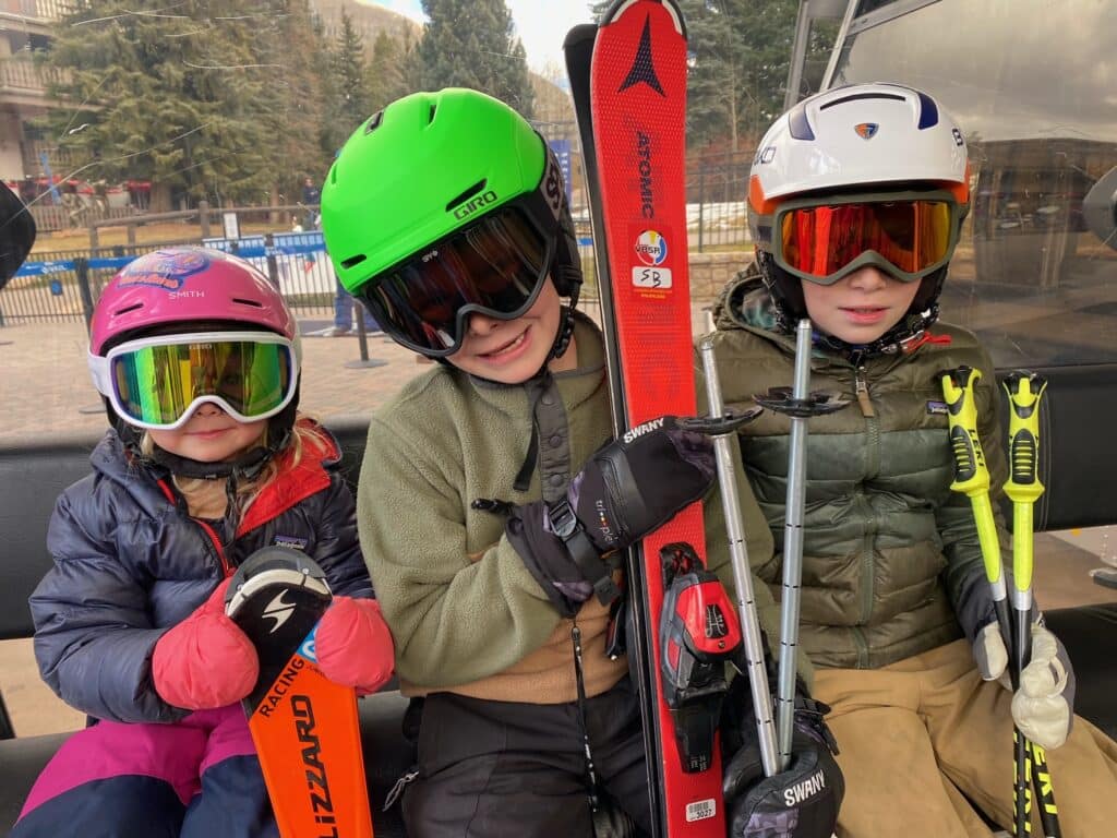 Kids in helmets ready to ski with junior rentals from Vista Bahn