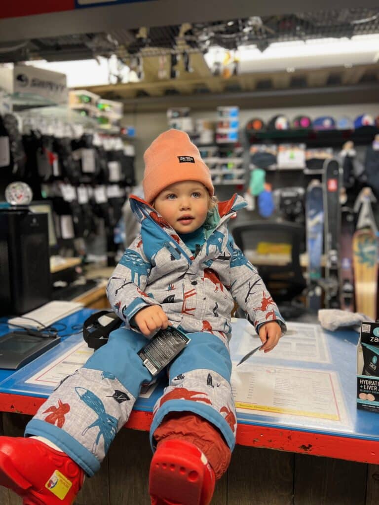 Toddler trying on ski gear at Vista Bahn Ski Rentals