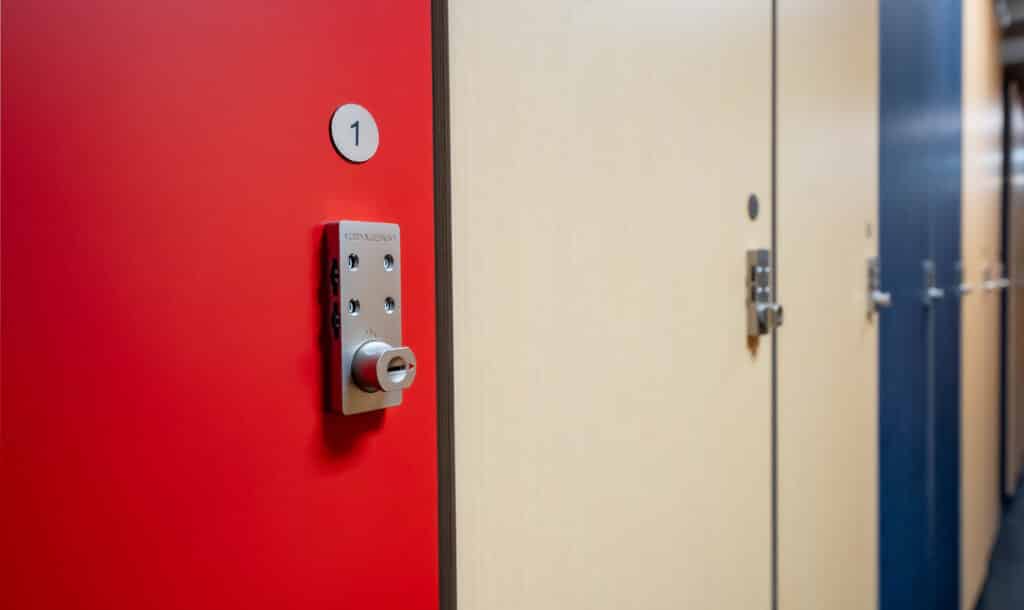 Red ski locker with number 1 and lock mechanism, part of seasonal storage options at Vista Bahn Ski Rentals in Vail, Colorado.